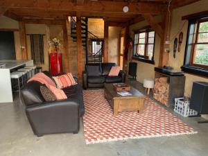 a living room with a couch and a coffee table at The Muddy in Alexandra