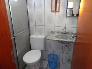 a small bathroom with a toilet and a sink at FARO FINO 104 DISNEY in Goiânia