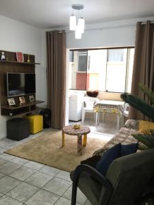 a living room with a couch and a table at Apto ótima localização in Capão da Canoa