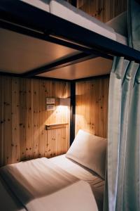 a bedroom with a bed and a window at Star Hostel Taipei East in Taipei
