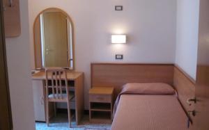 Postel nebo postele na pokoji v ubytování Albergo Moretti