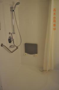 a shower in the corner of a bathroom at ibis Istres Trigance in Istres