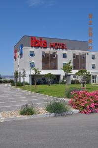 a lions hotel with a lot of flowers in front of it at ibis Istres Trigance in Istres