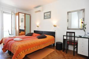 a bedroom with a large bed and a desk at Zadar Old Town Apartments II in Zadar