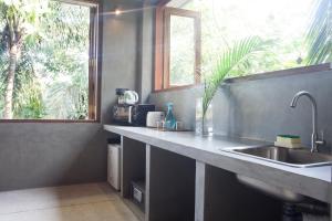 a kitchen counter with a sink and a window at Serene Villa in Hiriketiya