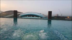 a large building in the middle of a body of water at Emira Residence Sek 13 Shah Alam Wi-Fi Netflix in Shah Alam
