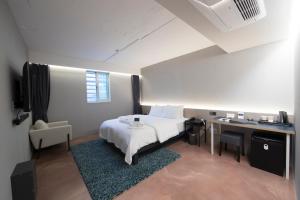 1 dormitorio con cama blanca, escritorio y silla en HOTEL H, en Seúl 20 fotos más