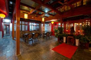 a dining room with a table and chairs in a building at Qianmen Courtyard Hotel in Beijing