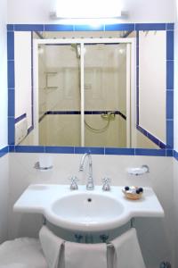 a bathroom with a sink and a mirror at Aurora Residence in Amalfi +13 photos