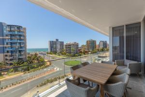 a dining room with a view of the ocean at Astina Suites, Forster in Forster