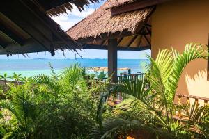 a resort with a view of the beach and the ocean at Beyond The Blue Horizon Boutique Bungalows in Haad Chao Phao