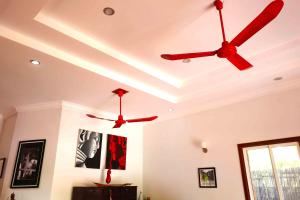 two ceiling fans in a room with white walls at Villa b.Maison d'Hôtes Angkor in Siem Reap