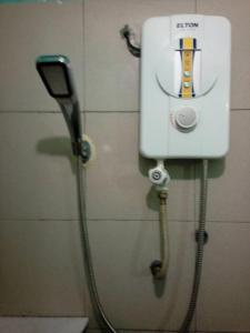 a soap dispenser on a wall in a bathroom at Petaling Street Hotel Chinatown in Kuala Lumpur