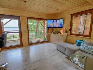 a living room with a couch and a flat screen tv at OW Magdalena in Boszkowo