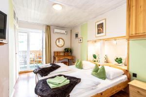 two twin beds in a room with a balcony at Kaktusz Villa Heviz in Hévíz