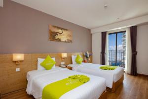 Ένα ή περισσότερα κρεβάτια σε δωμάτιο στο Ale Nha Trang Hotel