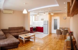 a living room with a couch and a table at Apartment Luxury Explorer in Podgorica