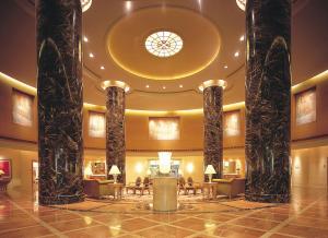 a lobby of a hotel with columns and a ceiling at Hotel Okura Fukuoka in Fukuoka