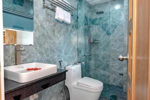 a bathroom with a white toilet and a sink at Little Boss Homestay in Hoi An +51 photos