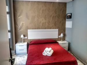 Łóżko lub łóżka w pokoju w obiekcie Apartamentos El Vestuario