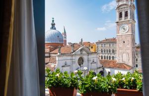 a view from a window of a building with a clock tower at Hotel Scandinavia - Relais in Venice