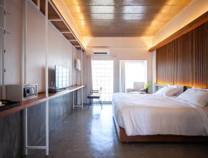 a bedroom with a large bed and a television at Laekhon Nonbai in Nakhon Si Thammarat +81 photos