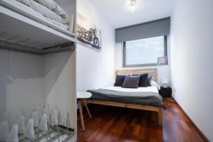 Apartamento Camp Nou 101 في لوسبيتاليت دي يوبريغات: غرفة نوم بسرير ونافذة