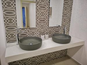 a bathroom with a sink and a mirror at Dimitra Hotel in Hersonissos