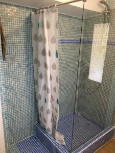a shower with a shower curtain in a bathroom at Orange Terrace Hostel in Albufeira