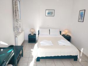 a bedroom with two beds and two side tables at Konstantinos Apartments in Agia Effimia