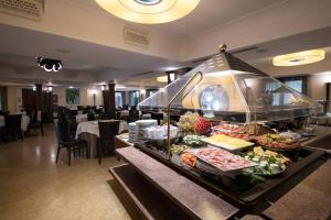 a buffet line in a restaurant with food on it at Artemis Hotel in Cefalù