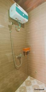 a shower in a bathroom with a shower head at Ngoc's Garden House in Phong Nha