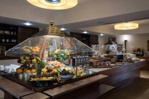a buffet line with fruits and vegetables on display at Artemis Hotel in Cefalù