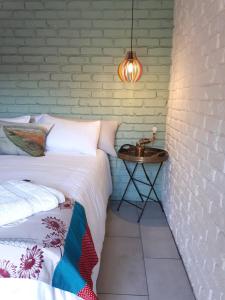 a bedroom with a bed and a side table at Oppermans Villa in Pretoria