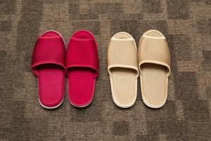 three pairs of shoes sitting next to each other at Dormy Inn Premium Shibuya-jingumae in Tokyo