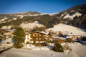 a ski lodge in the snow in a mountain at Landhaus Maridl in Hart im Zillertal