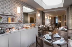 a restaurant with a counter and tables and chairs at Longchamp Elysées in Paris