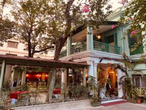 a building with a restaurant in front of it at The Elgin Fairlawn, Kolkata in Kolkata
