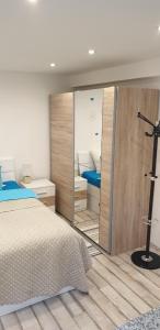 a bedroom with a bed and a large mirror at Apartman Sevilya in Kostrena
