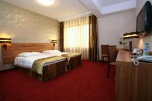 
Łóżko lub łóżka w pokoju w obiekcie Hotel Duet Budget Centrum
