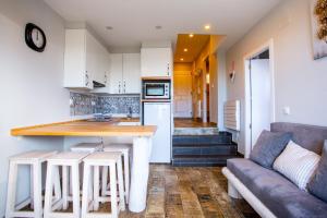 a kitchen with a couch and a kitchen island with stools at Silencio in Sierra Nevada