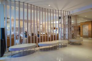 a lobby with two benches and tables in a building at Canyelles Platja in Roses