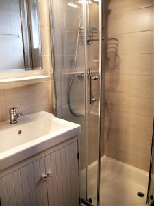 a bathroom with a shower and a sink at Pension Kitty in Pörtschach am Wörthersee