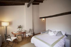 a bedroom with a bed and a table and chairs at Altalea by Clabao in Pamplona