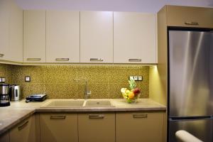 a kitchen with a sink and a refrigerator at Melina Skiathos in Kolios