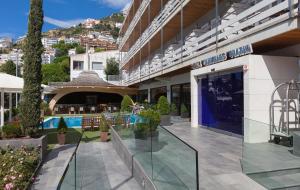 a large building with a swimming pool and a resort at Canyelles Platja in Roses