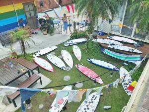 a bunch of surfboards are lined up on the grass at Tabist Guest house Pumping Surf in Hyuga