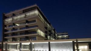 a tall building at night with its lights on at The Met Hotel Thessaloniki, a Member of Design Hotels in Thessaloniki