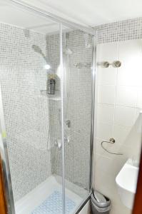 a shower with a glass door in a bathroom at B&B Lost in Trastevere in Rome