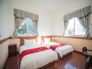Postel nebo postele na pokoji v ubytování 山城天嵐庭園民宿